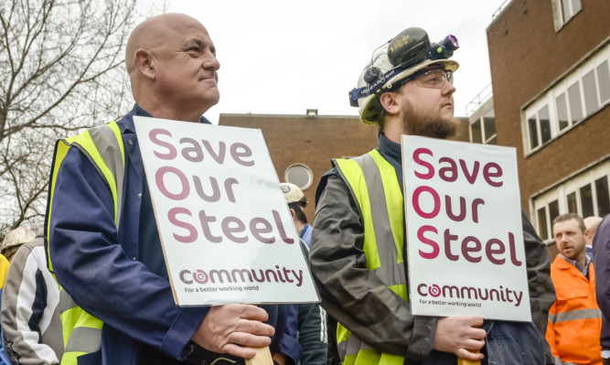 Steelworkers at the TATA plant at Port Talbot wait to meet UK Business Secretary Sajid Javid.