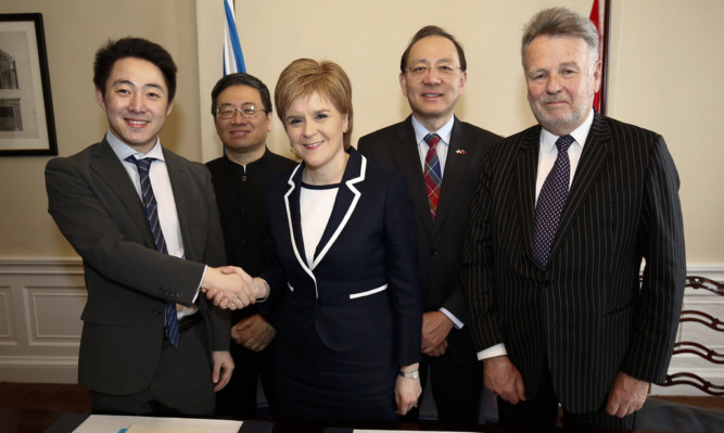 First Minister Nicola Sturgeon came under pressure to explain why a memorandum of understanding with China was not made public.