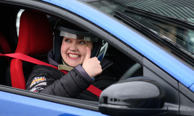 Scottish Conservative leader Ruth Davidson sits in a blue car at Knockhill racing circuit.