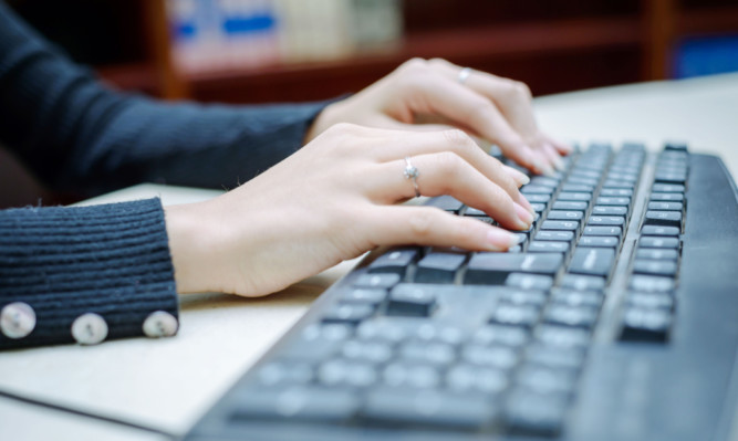 Closeup portrait of woman's hand typing on computer keyboard