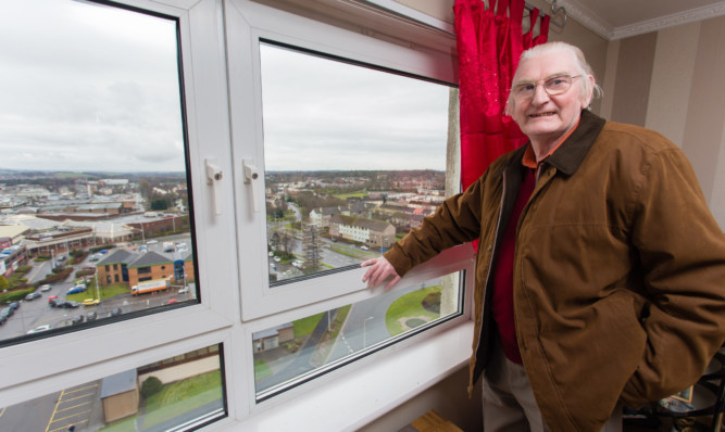 Raeburn Heights resident Danny Murphy shows off the view from his 13th floor flat in Glenrothes.