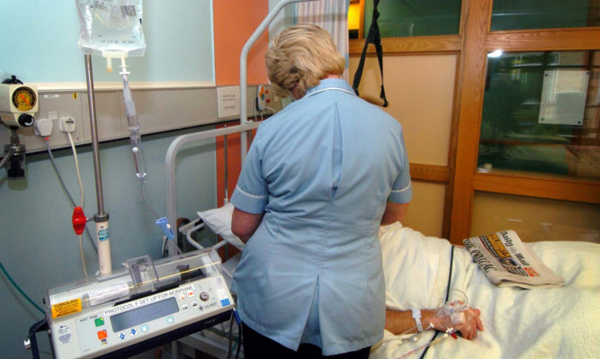 Undated file photo of a nurse treating a patient. Almost two-thirds of nurses have considered quitting their jobs in the last 12 months because they are so stressed, a survey has found. PRESS ASSOCIATION Photo. Issue date: Saturday August 31, 2013. Swingeing cuts to the numbers of nurses in the NHS have left many feeling overburdened in their work and unable to give the care they want, the Daily Mirror said. See PA story HEALTH Nurses. Photo credit should read: David Jones/PA Wire