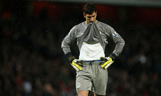 Wigan Athletic's Joel Robles stands dejected as his side are relegated.