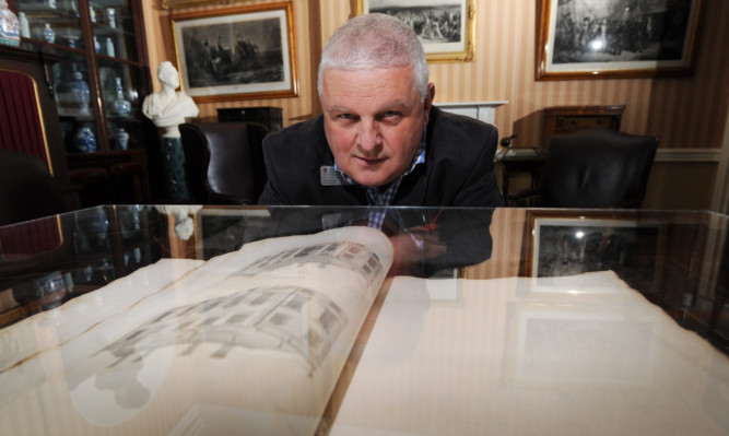 NTS manager John McKenna with the Vitruvius Scoticus showing a design for the house.