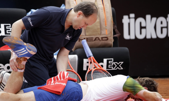 Murray receives medical care during his match with Marcel Granollers.