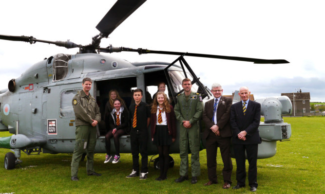The flight crew from the Lynx helicopter with Montrose Academy pupils, depute head teacher Bruce Pandrich and head teacher Dr John Cavanagh.