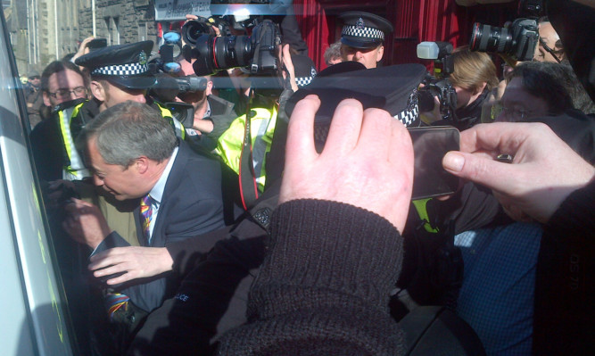 Ukip leader Nigel Farage is escorted from the pub by police.