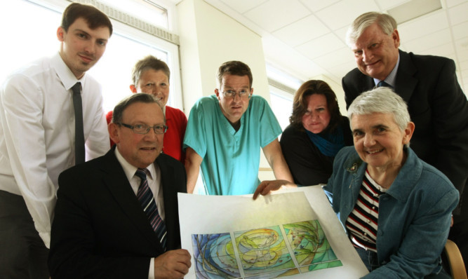 Front: Organ donation chairman Sandy Watson and artist Liz Rowley with the window design, and back, from left, Tayside NHS Board Endowment Fund trustees Matthew Landsburgh, Alison Rogers, Dr Stephen Cole and organ donation committee members June Osborne and Alex Stephen.