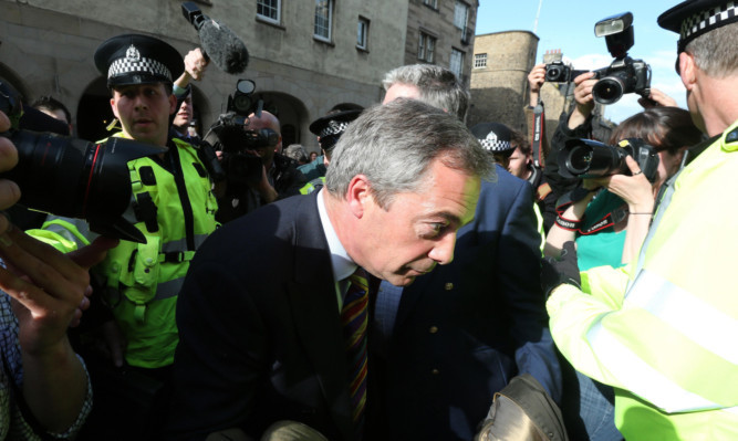 Nigel Farage is escorted by police during Thursday's melee.