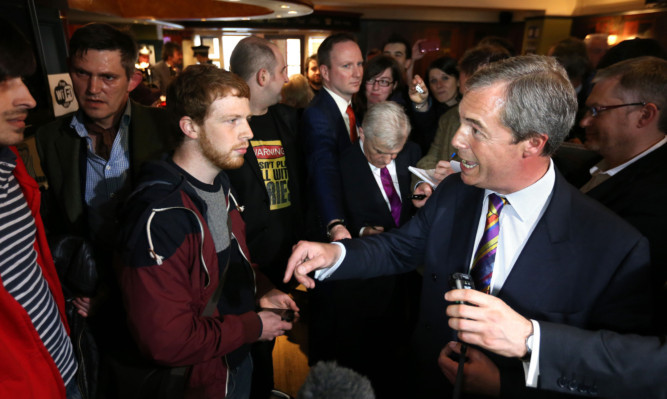 Nigel Farage talks with protesters inside the Canon's Gait pub.