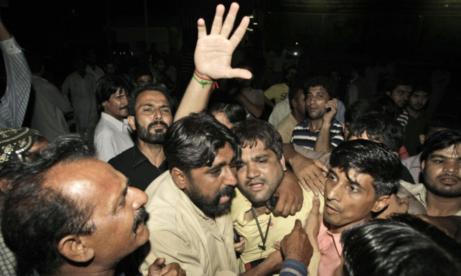 Friends of Zahra Shahid Hussain mourn her death at a hospital in Karachi.