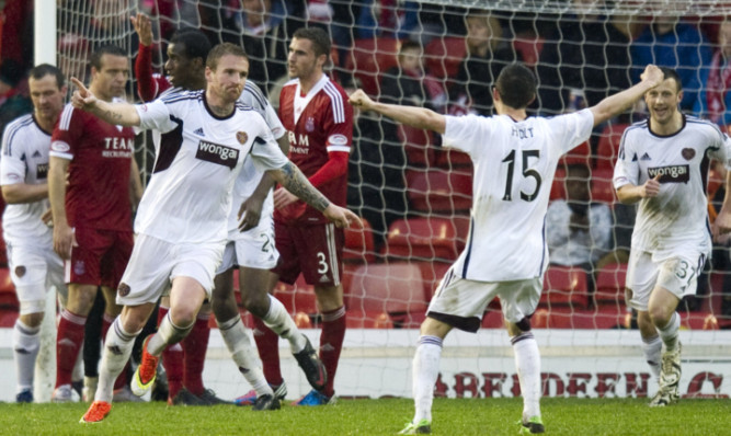 Hearts' Ryan Stevenson (left) wheels away to celebrate his goal.