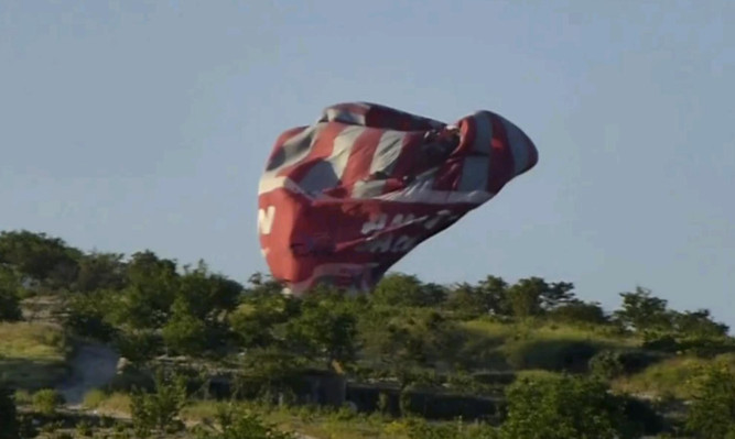 This image from video provided by E. Wayne Ross shows one of the balloons crashing to the ground.