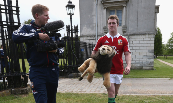Stuart Hogg protecting the Lions mascot from some close scrutiny.
