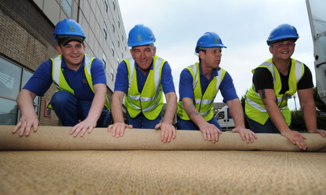Removing carpets for recycling from the former Hilton Hotel were (from left) Stuart Keddie, Bruce Glen, Colin Cuthbert and Kieran Smith.
