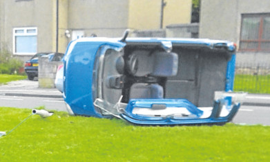 Firefighters cut away the car's roof to free the woman.