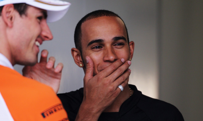 The drivers share a joke during practice for the Chinese Grand Prix in 2011.