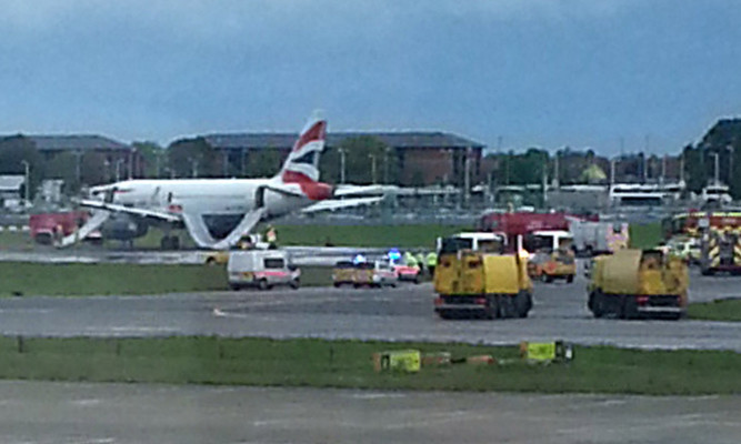 An image showing emergency vehicles around the plane.