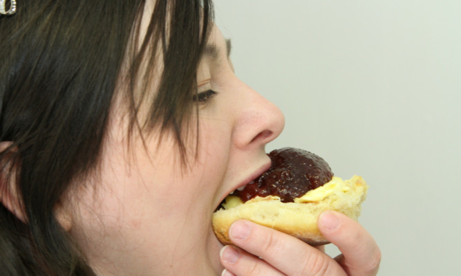 Courier reporter Kirsty Topping tucking in to one of the award-winning scones.