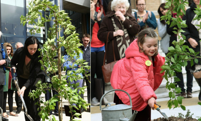 Jane's mother Karen and sister Isla helping to plant the tree.