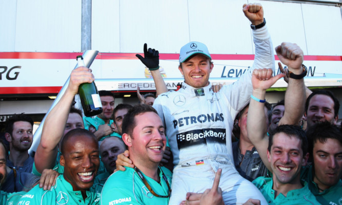 Nico Rosberg celebrates his victory with his Mercedes team.