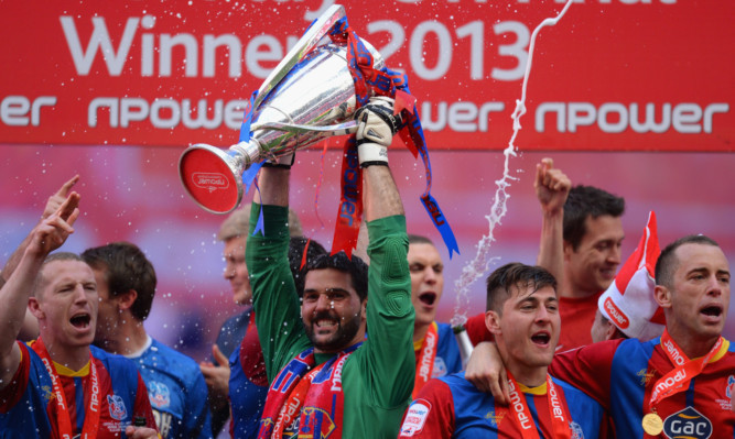 Palace goalkeeper Julian Speroni with the trophy as the celebrations get under way.