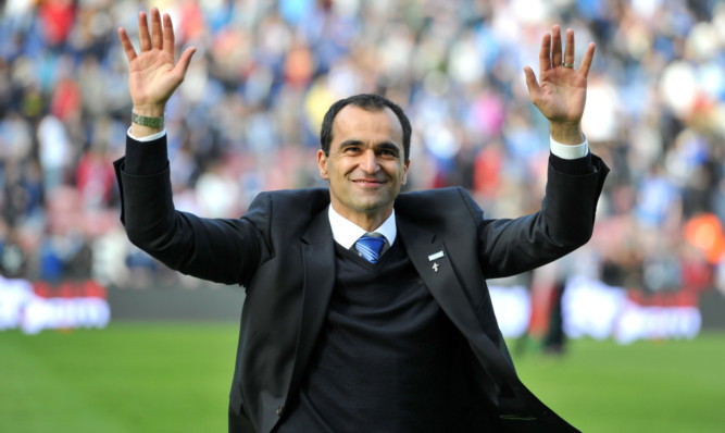 Wigan Athletic mamager Roberto Martinez salutes the fans after the Barclays Premier League match at the DW Stadium, Wigan. PRESS ASSOCIATION Photo. Picture date: Sunday May 19, 2013. See PA story SOCCER Wigan. Photo credit should read: Martin Rickett/PA Wire. RESTRICTIONS: Editorial use only. Maximum 45 images during a match. No video emulation or promotion as 'live'. No use in games, competitions, merchandise, betting or single club/player services. No use with unofficial audio, video, data, fixtures or club/league logos.