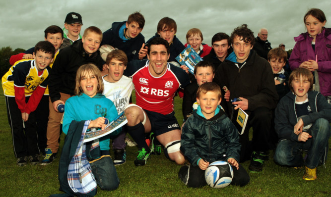 Player Kelly Brown, centre, with youngsters at JJ Coupar Park, Blairgowrie.