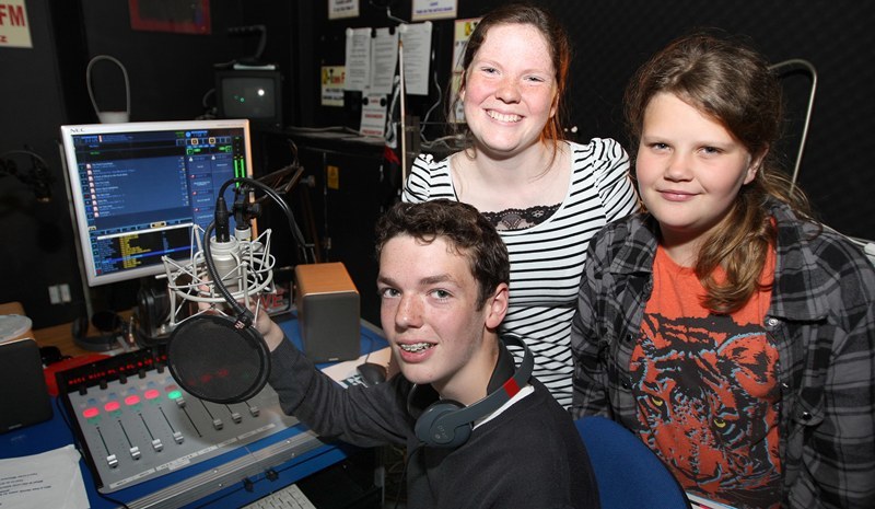 Kris Miller, Courier, 30/07/10, News. Picture today at K-Town FM. The community station which was set up with grants from the Big Lottery was celebrating the end of another season (they are only allowed to broadcast 4 weeks a year) today. Pic shows presenters Ciaran and Caitlin Sneddon  (Chip and Bink are their on air names) with competition winner Laura Brannan in the studio.