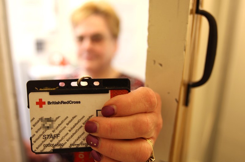 Kris Miller, Courier, 30/07/10, News. Picture today at Red Cross Shop, Cupar. Pic shows Effie Trial (shop manager) showing I.D. Pic is to illustrate that people should ask for identity if people knock on doors asking for donations. Story about fraudster from Cupar office.