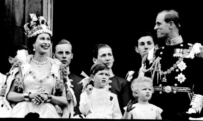 The royal family on the balcony of Buckingham Palace after the coronation at Westminster Abbey.