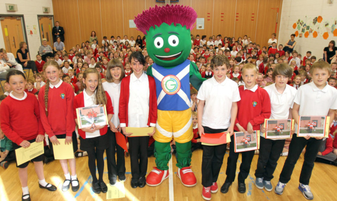 The 2014 Commonwealth Games mascot, Clyde, visited the Burnside Primary Schools Highland Games-themed sports day.