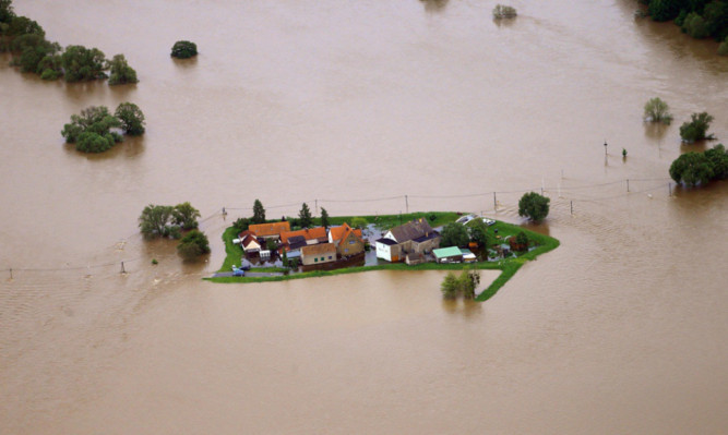 The swollen river Mulde and the floods around some houses north of Eilenburg, Germany.