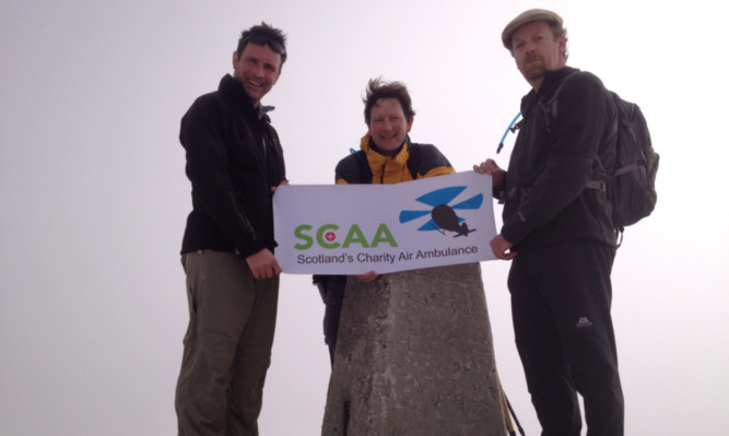 On the summit of Ben Nevis are, from left, John Bullough, James Gray-Cheape and John Forbes-Leith.