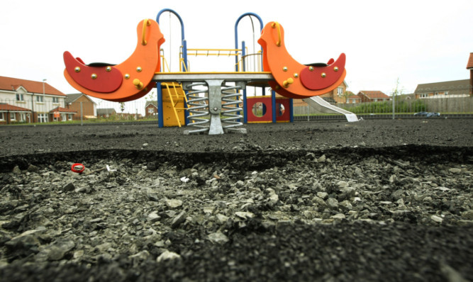 The damaged playpark surface.