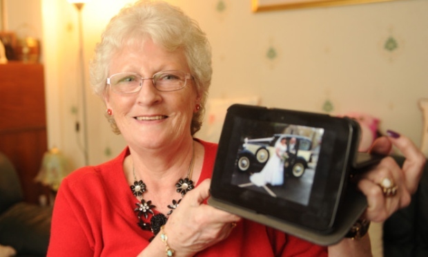 Moyra with a picture of her son’s wedding. She praised Ballumbie Court care home staff after they arranged for her mother to view the happy day on Skype.