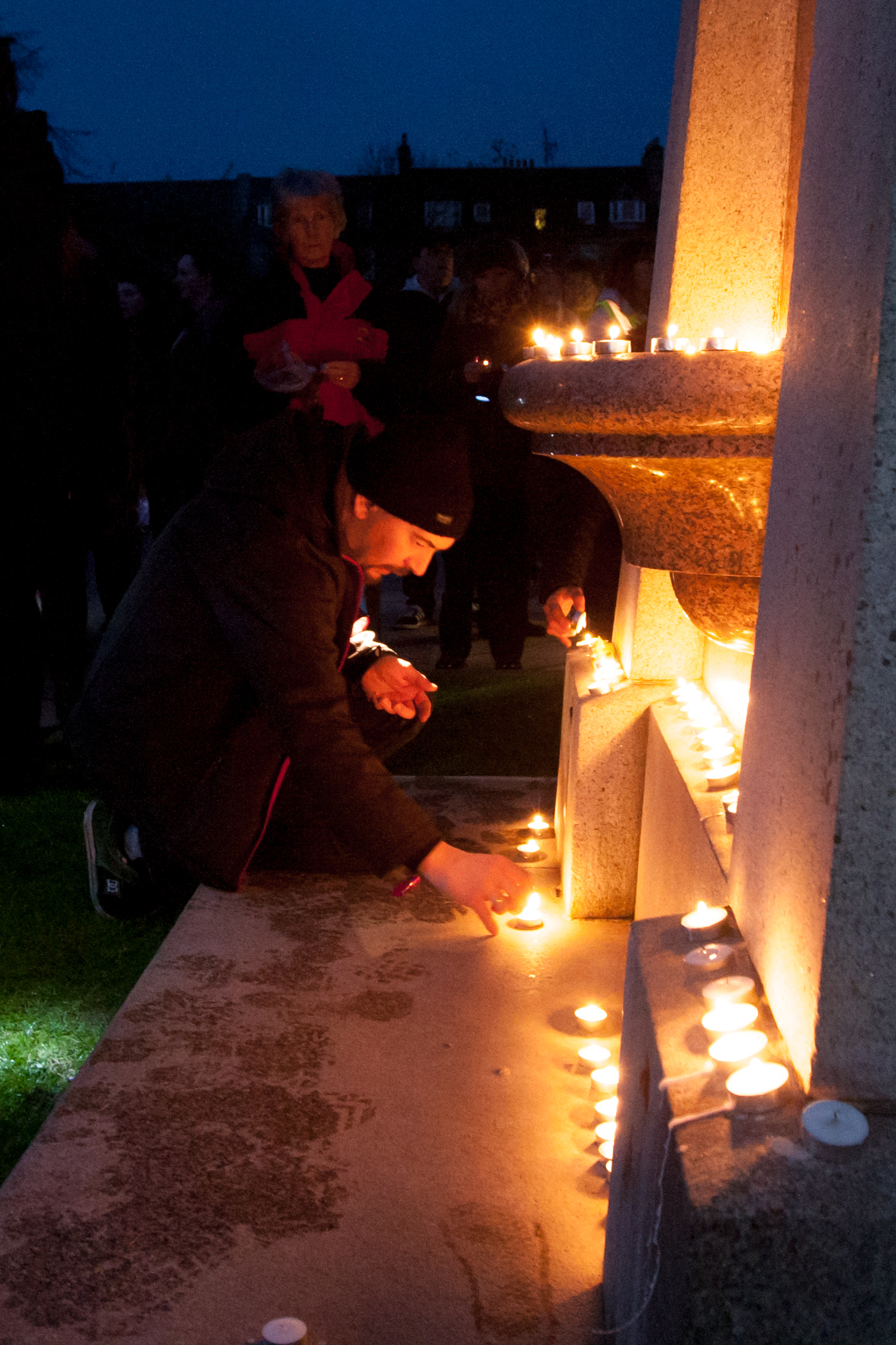 A participant lights a candle