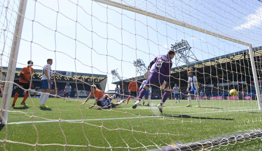 Harry Souttar (centre) heads home Dundee Utd's fourth goal at Kilmarnock.