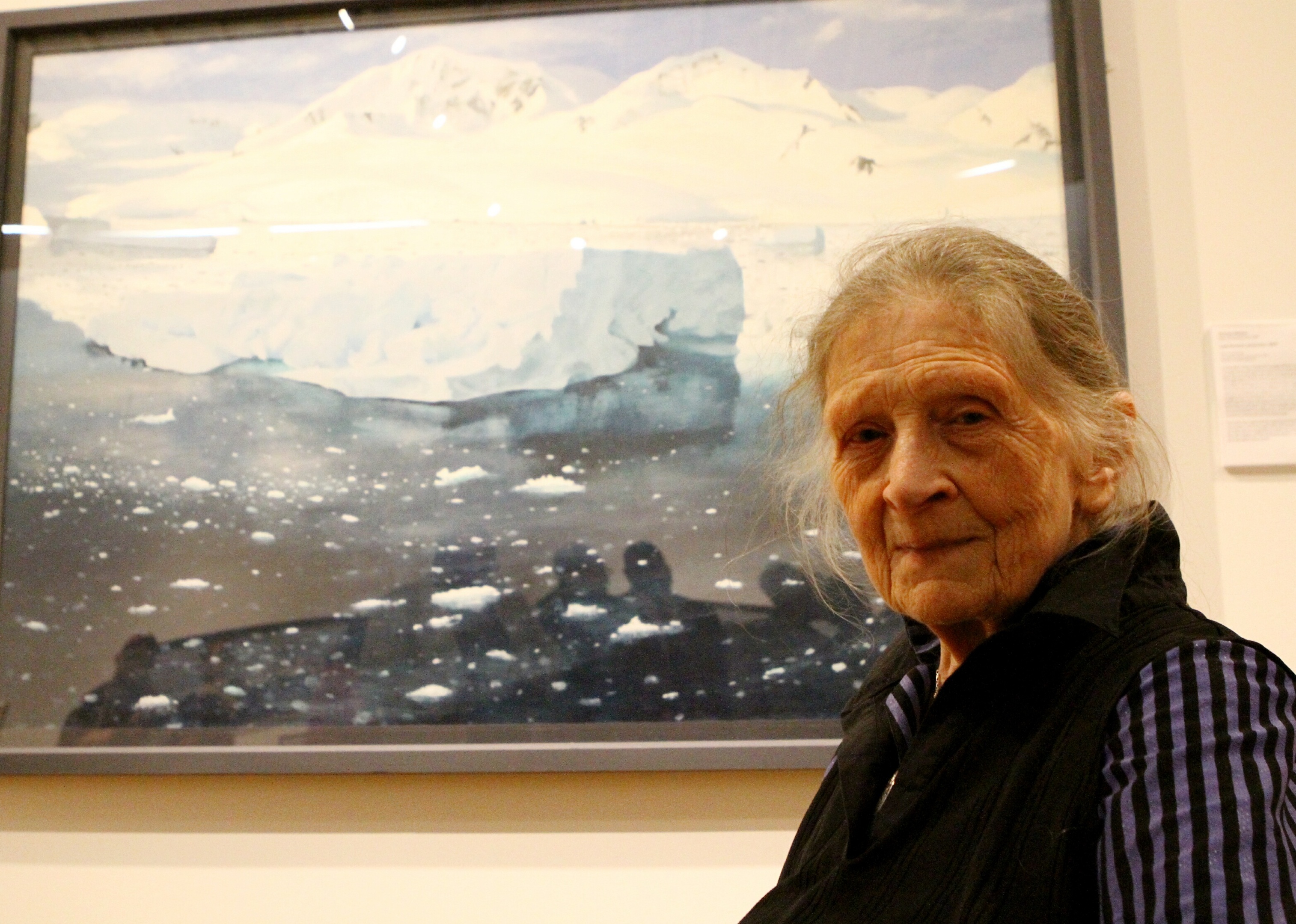 Frances Walker beside one of her paintings in the exhibition.