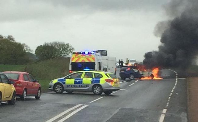 The Ford Fiesta on fire following Saturday morning's crash on the A909 in Fife.