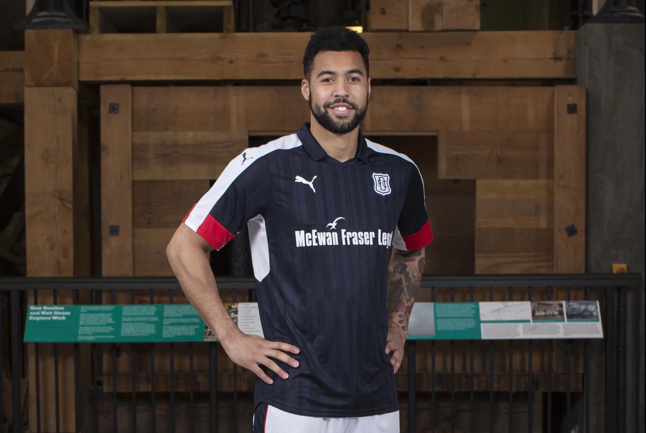 Dundee's Kane Hemmings models the club's  new home kit.