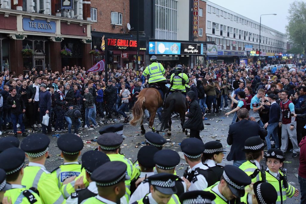 LONDON, ENGLAND - MAY 10: Police horses charge at West Ham fans as they become violent and start throwing bottles at police outside the West Ham United FC's Boleyn Ground on May 10, 2016 in London, England. Tonights Premier League match against Manchester United is West Ham United's last game at the Boleyn Ground, bringing to an end 112 years of the club's history at the ground. The club will move into the Olympic Stadium next season, making way for developers and plans for 800 new homes where the stadium now stands. (Photo by Dan Kitwood/Getty Images)