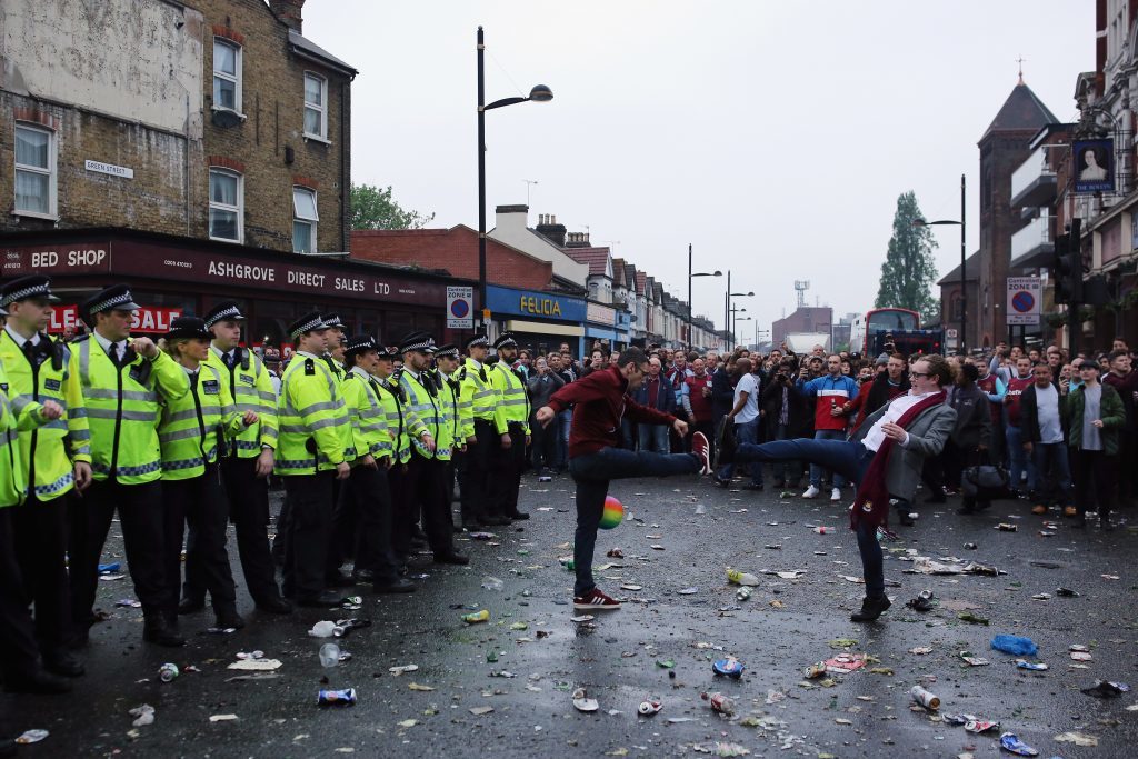 LONDON, ENGLAND - MAY 10: Police officers form a barrier after West Ham fans became violent and threw projectiles at police outside the West Ham United FC's Boleyn Ground on May 10, 2016 in London, England. Tonights Premier League match against Manchester United is West Ham United's last game at the Boleyn Ground, bringing to an end 112 years of the club's history at the ground. The club will move into the Olympic Stadium next season, making way for developers and plans for 800 new homes where the stadium now stands. (Photo by Dan Kitwood/Getty Images)