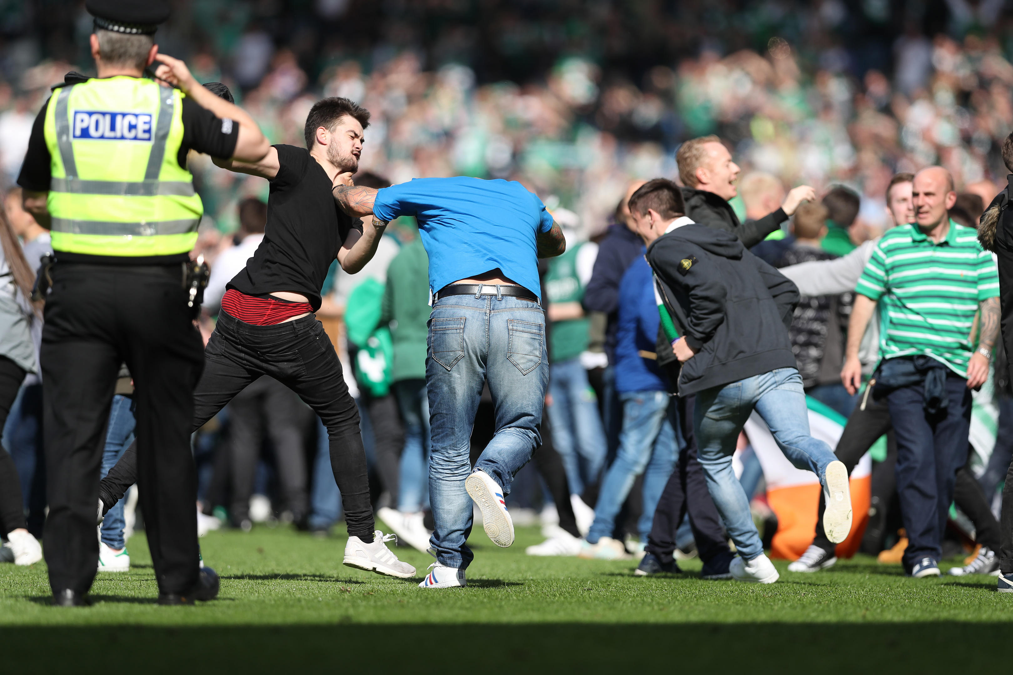 Hibs fans invade the pitch after the final whistle.