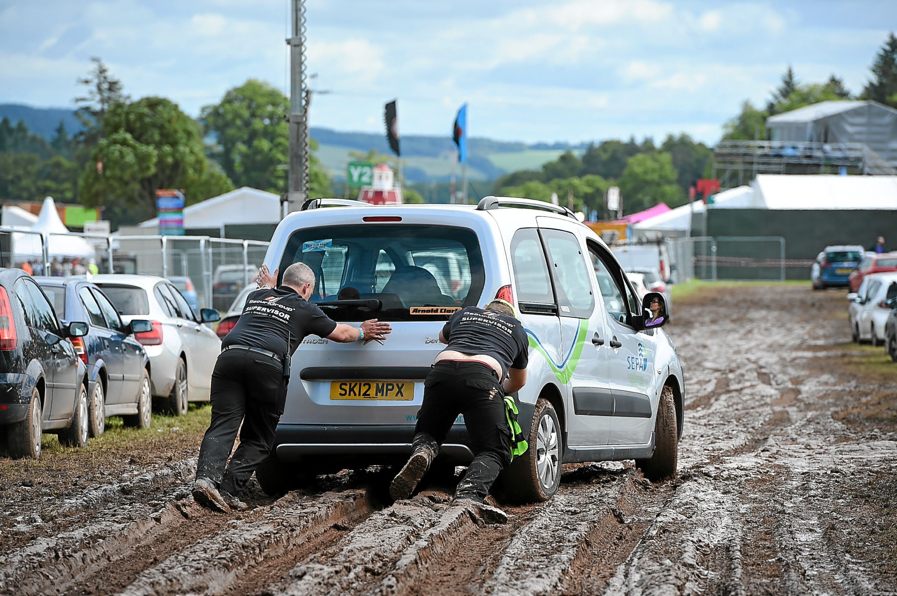 Cars struggle in the mud at last years T in the Park at Strathallan, where there was traffic chaos during the festival.