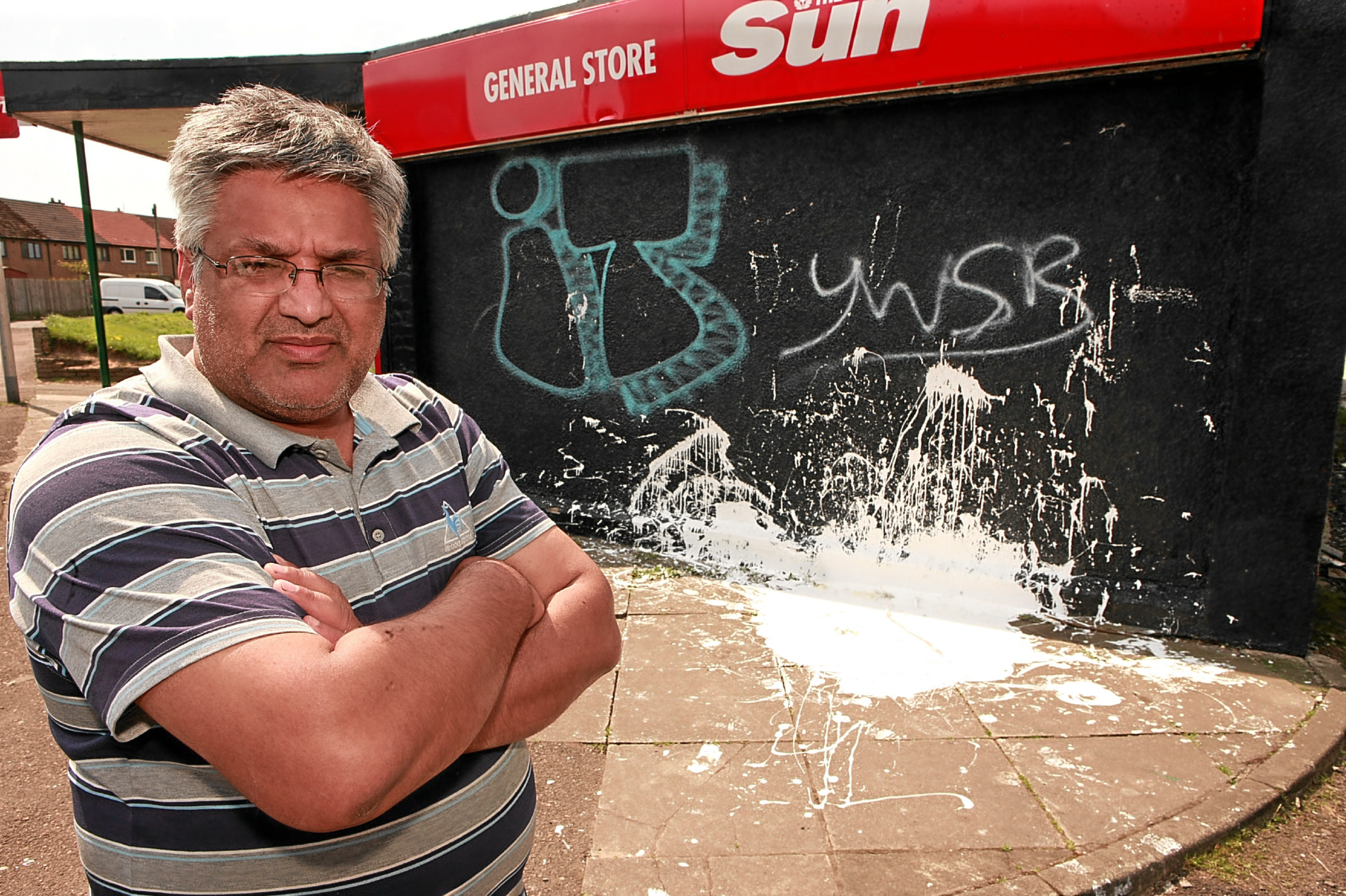 Ismal Din outside the vandalised shop in Fintry.