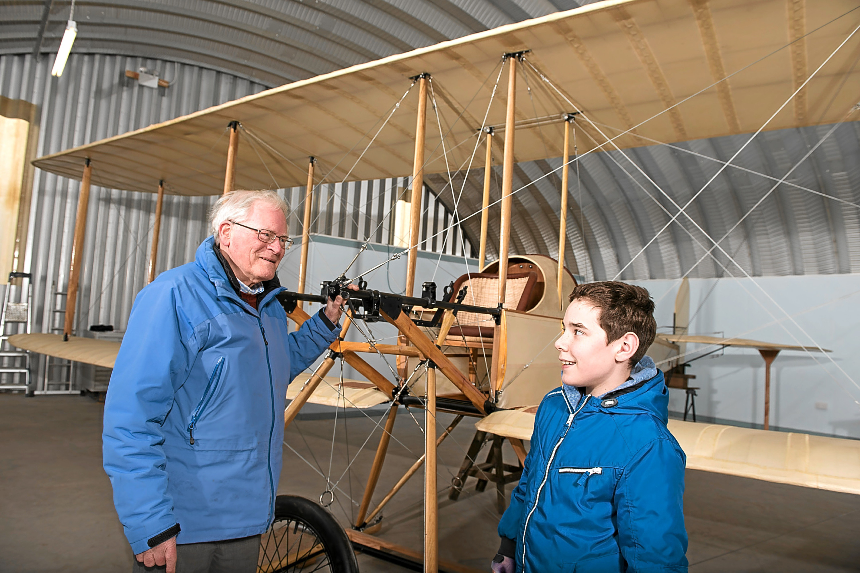 Alan Doe, chairman of the Montrose Air Station Heritage Centre, speaks to youngster Justine Paton beisde the replica BE2 plane.