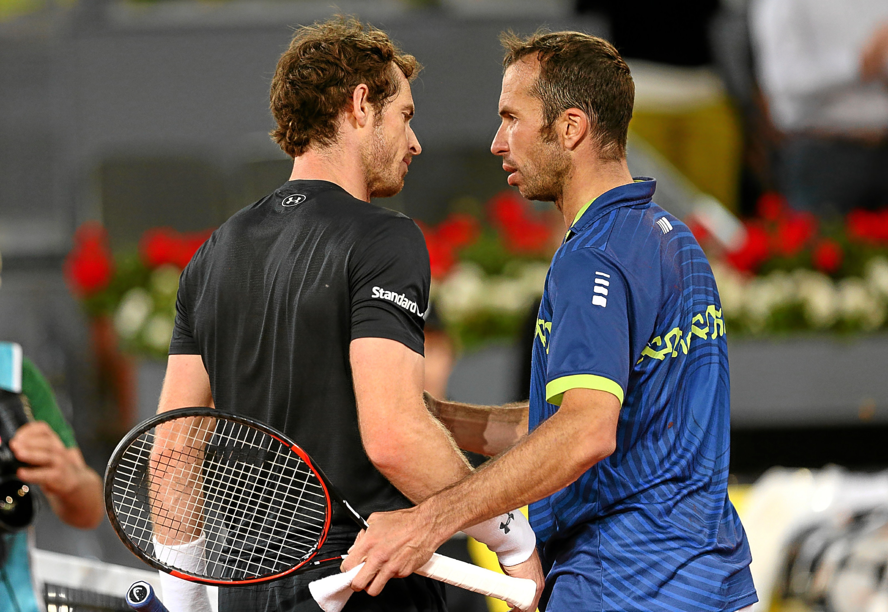 Andy Murray shakes hands at the net after his three set victory against Radek Stepanek at the Madrid Open.