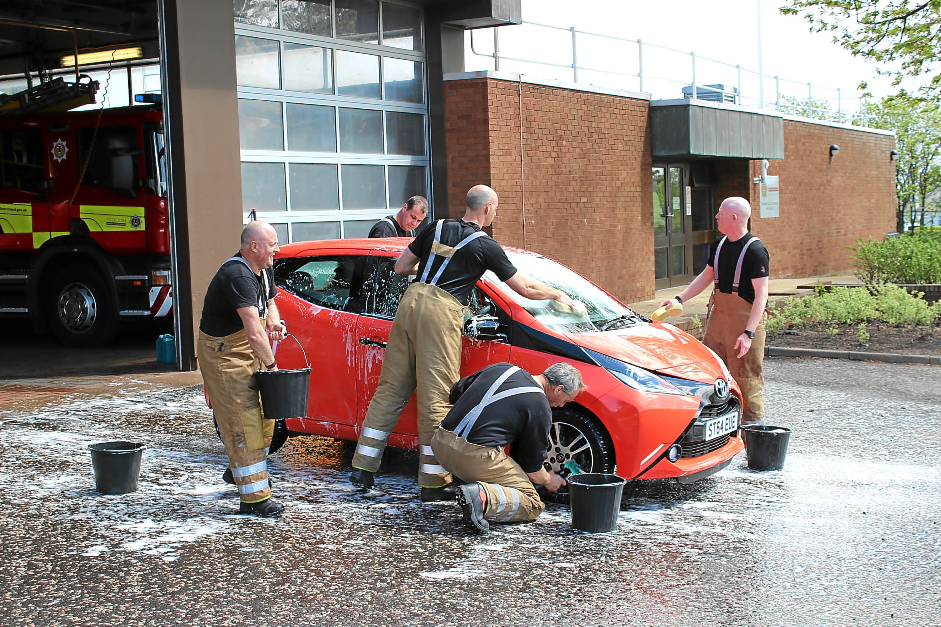 Firefighters from Kingsway East red watch wash cars for the Firefighters Charity.