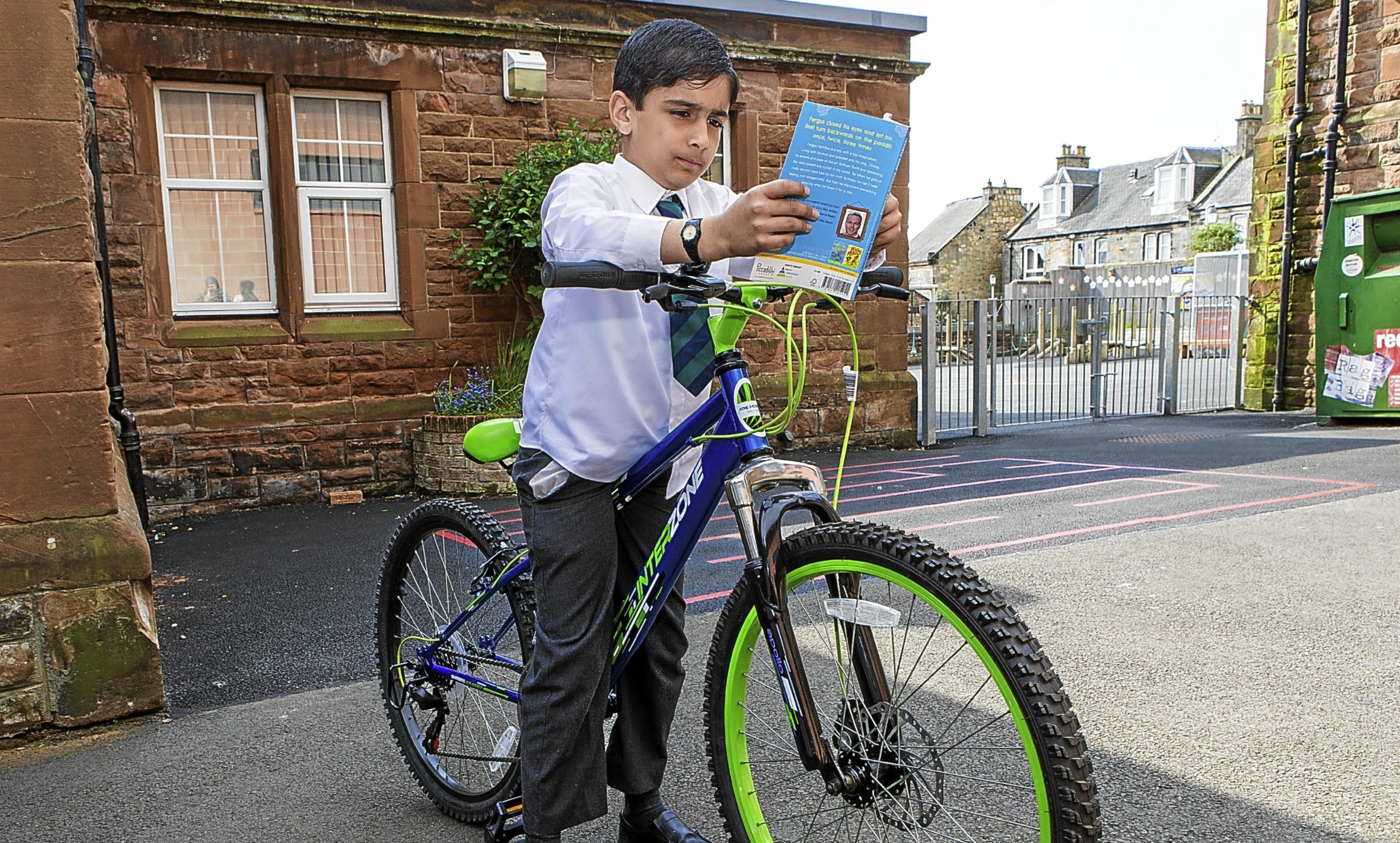 Daanyaal with his new bike and book from Sir Chris Hoy.